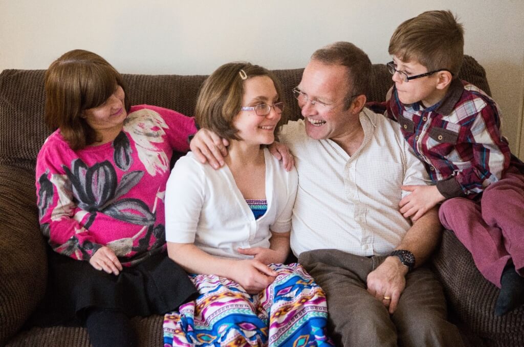 Family photo sitting on a sofa after receiving help from the Cornwallis Charity