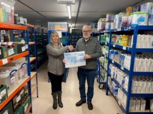 Eric presents the cheque to Wendy from the foodbank